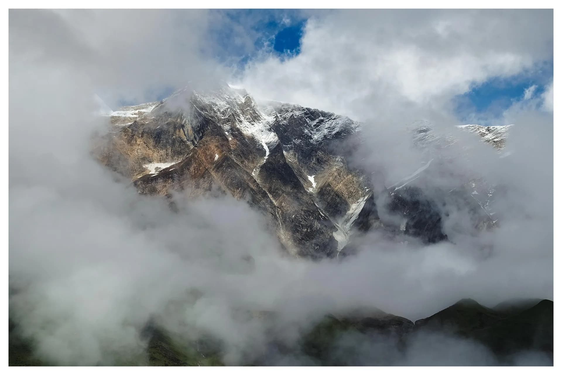 Snow peak wrapped in cloud at first light