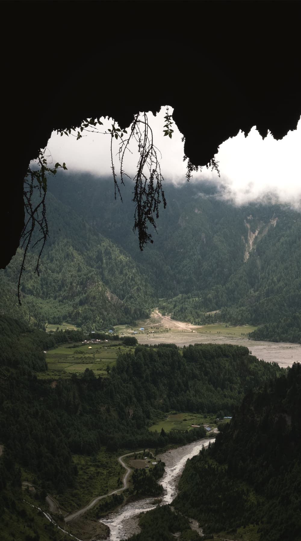 Mustang valley and river seen from the mouth of a cliffside cave