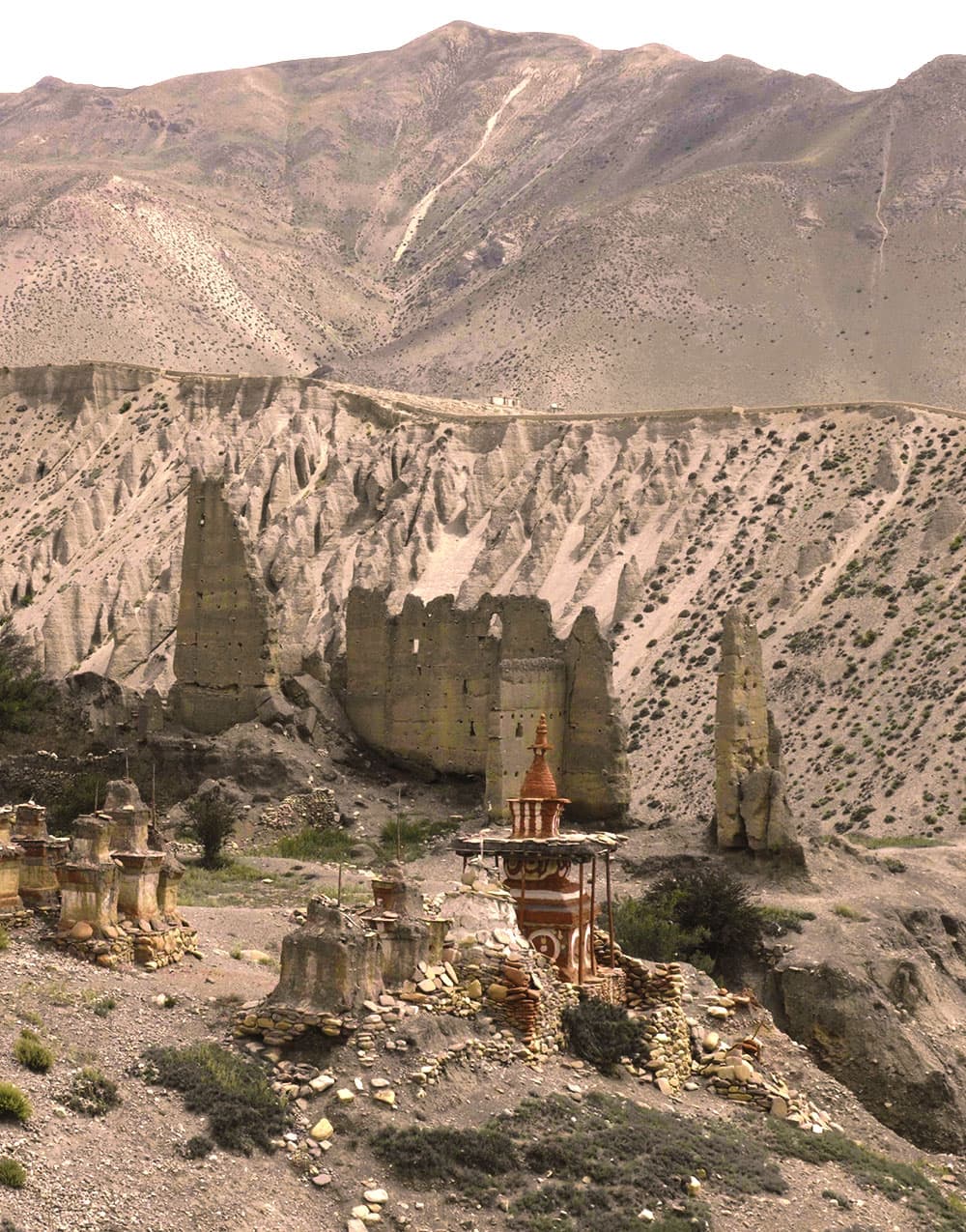 Ancient chortens and cave dwellings carved into the cliffs of Upper Mustang