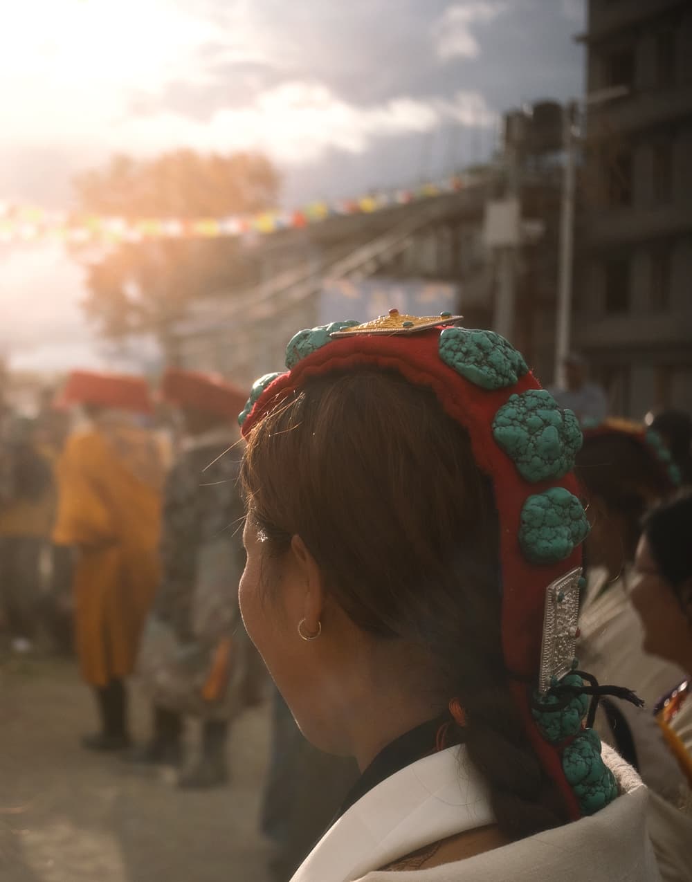 Woman in a traditional turquoise-studded headdress at a festival
