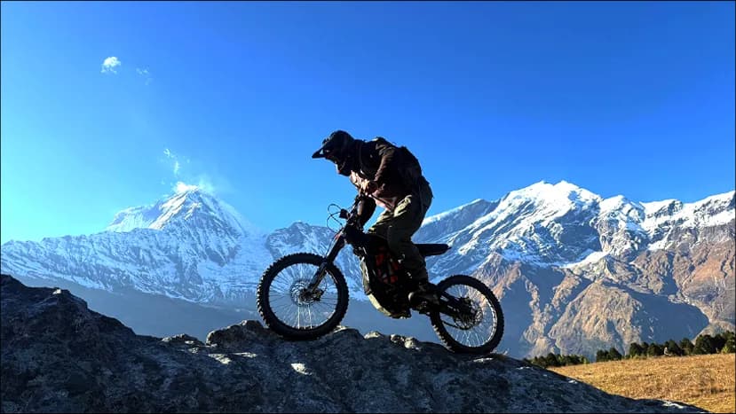 Rider lifting the front wheel on a ridge above the Mustang desert