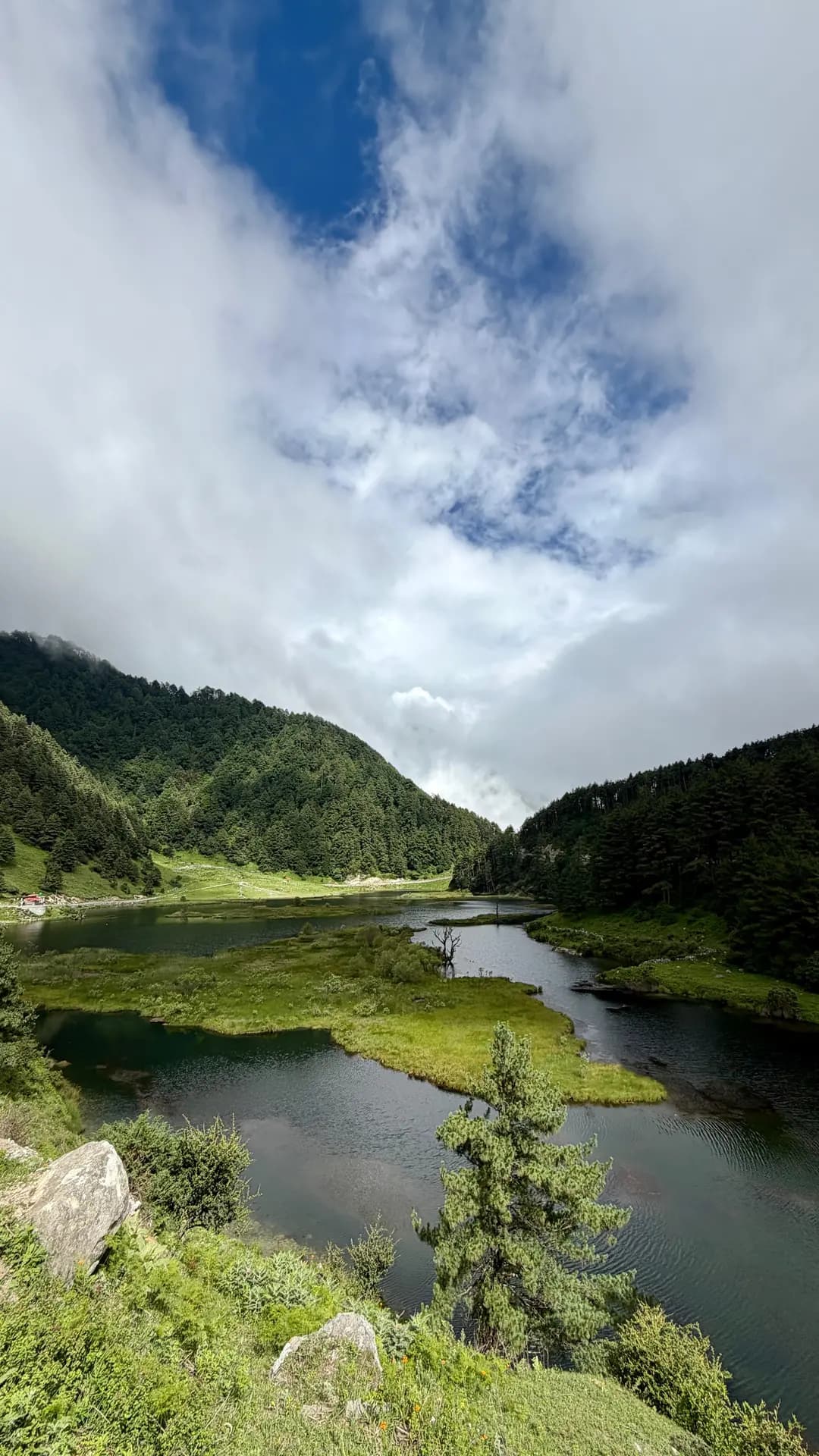 Titi lake held in the forested valley below the ridgeline