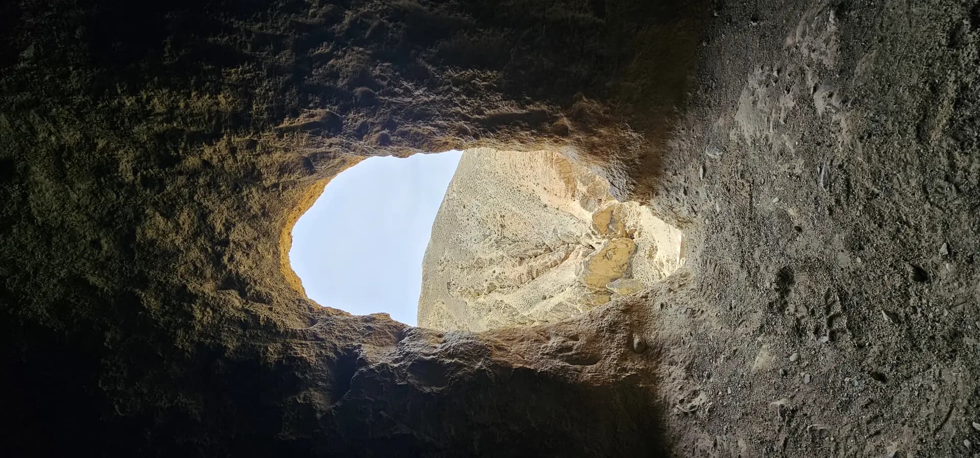 Cliff cave opening on the short hike above the camp
